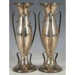 A pair of Art Nouveau hallmarked silver three-handled spill vases, Chester 1908. (2)