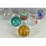 Six large glass paper weights, to include Murano examples.