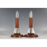 A pair of Vulcanite table / desk lighters, in the form of rocket shells, 18cm H.