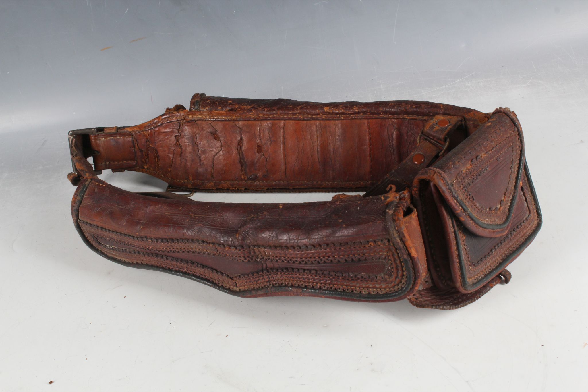 A Mexican hand stitched shot gun cartridge belt, 26 shots with leather weather flap and central