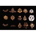 British Army cap badges and shoulder titles, including Green Howards, Bedfordshire, Liverpool and