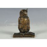 A bronze figurine of a tawny owl, perched on a naturalistic outcrop, signed.
