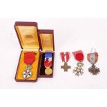 Legion d'Honneur Officier cased and Chevalier, ribbon, enamel decorated laurel wreath and stars, 3rd