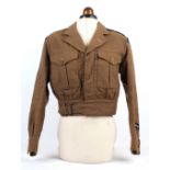 A British Army battle dress jacket, 1949 pattern, circa 1952, Eton College shoulder titles.