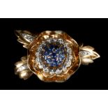 A fine circa 1940s French rose, gold, diamond and sapphire set cup brooch, the foliate clip back