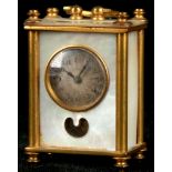 An Edwardian gold plated and mother-of-pearl miniature desk clock, having silvered dial and Arabic