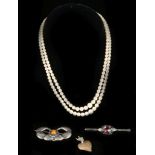A double strand cultured pearl necklace with a 14k clasp, silver 1900s brooch, silver bar brooch and