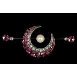 A Victorian gold crescent bar brooch, set with diamonds and rubies and centred with a pearl.