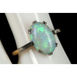 An 18ct gold / platinum, cabouchon opal solitaire ring.