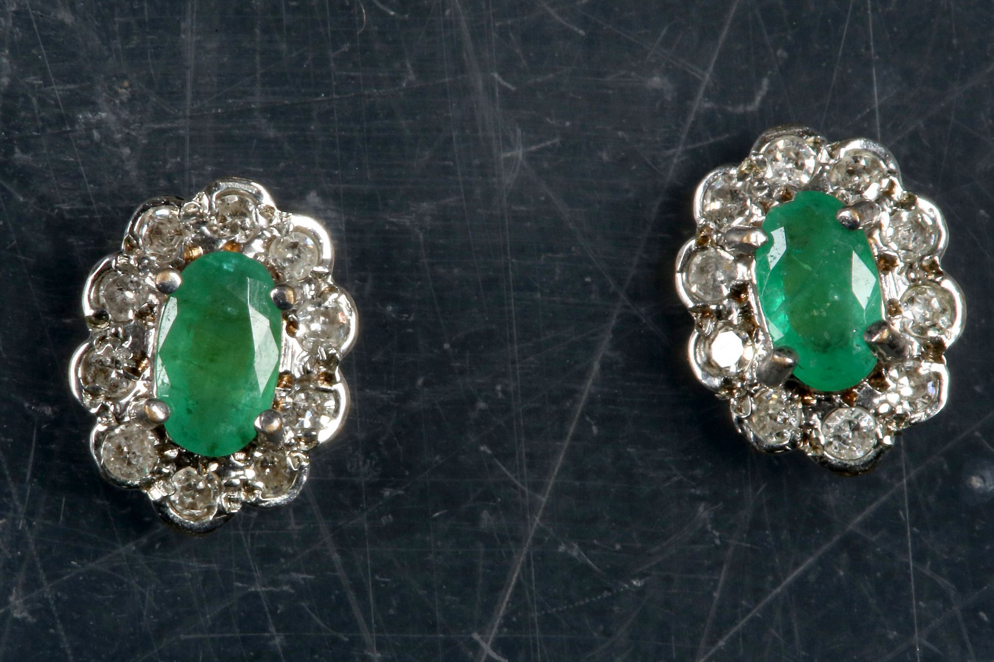 A pair of gold, emerald and diamond cluster earrings. (2)