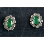 A pair of gold, emerald and diamond cluster earrings. (2)