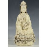 A Chinese statue, study of Gylin goddess seated on lotus leaf holding a ruyi and pomegranate