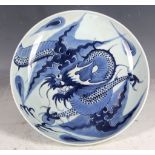 Chinese plate, blue glaze study of dragon and flaming pearl, 26.5cm diameter.