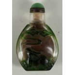 A Chinese Peking glass snuff bottle, green rabbits watching flaming pearl, 7cm.
