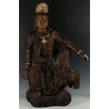 A Chinese wooden carving of Guanyin seated in Royal Ease, purchased from Heubel, Köln, 82cm H.