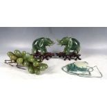 A Chinese circular butterfly pendant, together with two jade elephants with stands, and a