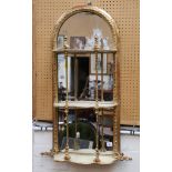 An antique carved and giltwood mirror backed, wall mounted shelves, with arched top, 98 L x 44cm W.