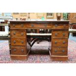 A 19th Century American walnut pedestal desk of small proportions, with an arrangement of nine