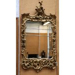 An antique rectangular mirror, and an elaborate carved and giltwood frame in high rococo style,