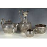 A good four piece Glasgow Hall marked silver tea set with complex repoussé decoration comprising