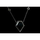 An 18ct white gold, hand made diamond pendant set with a 10.71ct black kite shaped diamond and