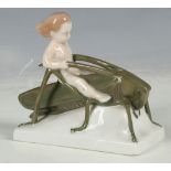 A Rosenthal porcelain group of putti riding a grasshopper, signed.