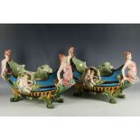 A pair of early 20th Century continental gondola fruit baskets, maiden figureheads with floral