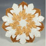 An earlyh 20th Century Meissen yard porcelain cabinet plate of small leaf shaped size enriched