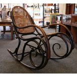 A Thonet rocking chair, rattan back and seat, hook back, spiral base, circa 1920.