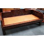 A Chinese hardwood bed with basket woven base, the headboard with incised decoration of Chilong