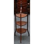 An Edwardian mahogany three tiered cake stand, with turned finial lifting handle on square section