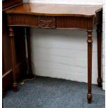 A pair of mahogany reproduction serpentine front neo-classical side tables on turned legs. (2)
