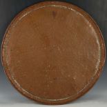 A large Arts & Crafts circular copper tray, with hand hammered ground, punched border and rolled