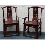 A pair of early 20th Century Chinese provincial hardwood armchairs having figural carved back