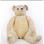 A 1930s J.K. Farnell golden mohair Teddy bear, English, with brown glass eyes, black stitched