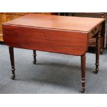 A 19th Century mahogany Pembroke table, with end drawers, on turned legs with brass caps and