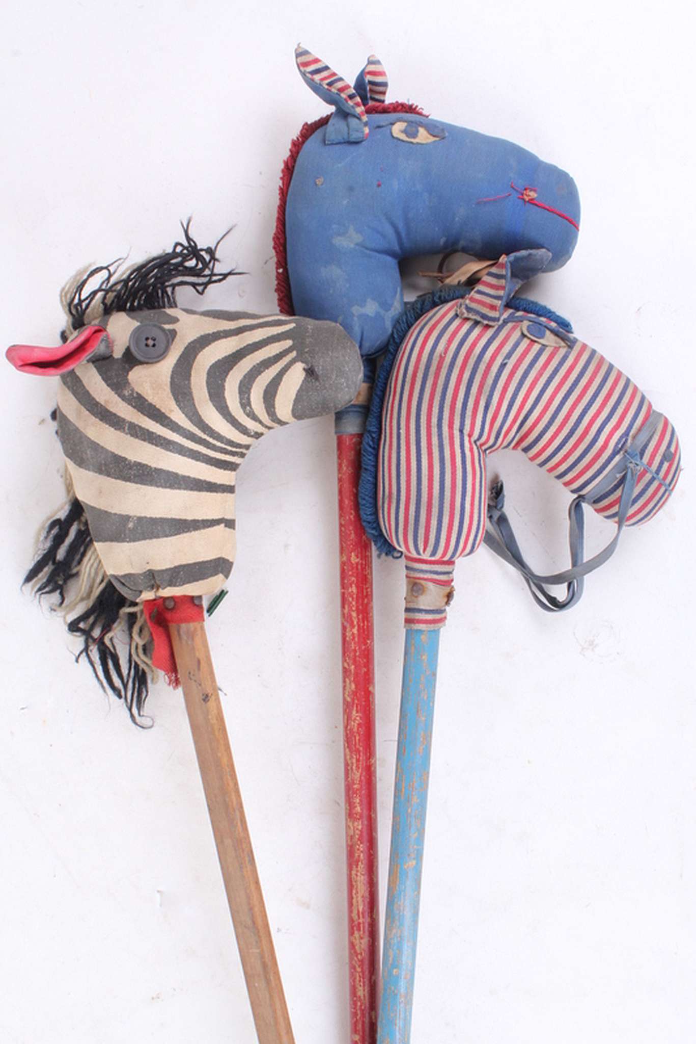 A small collection of toy hobby horses, to include one with wooden wheel and zebra example. (3)