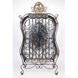 An ornate wrought iron free standing 35 bottle wine rack with semi-elliptical doors.