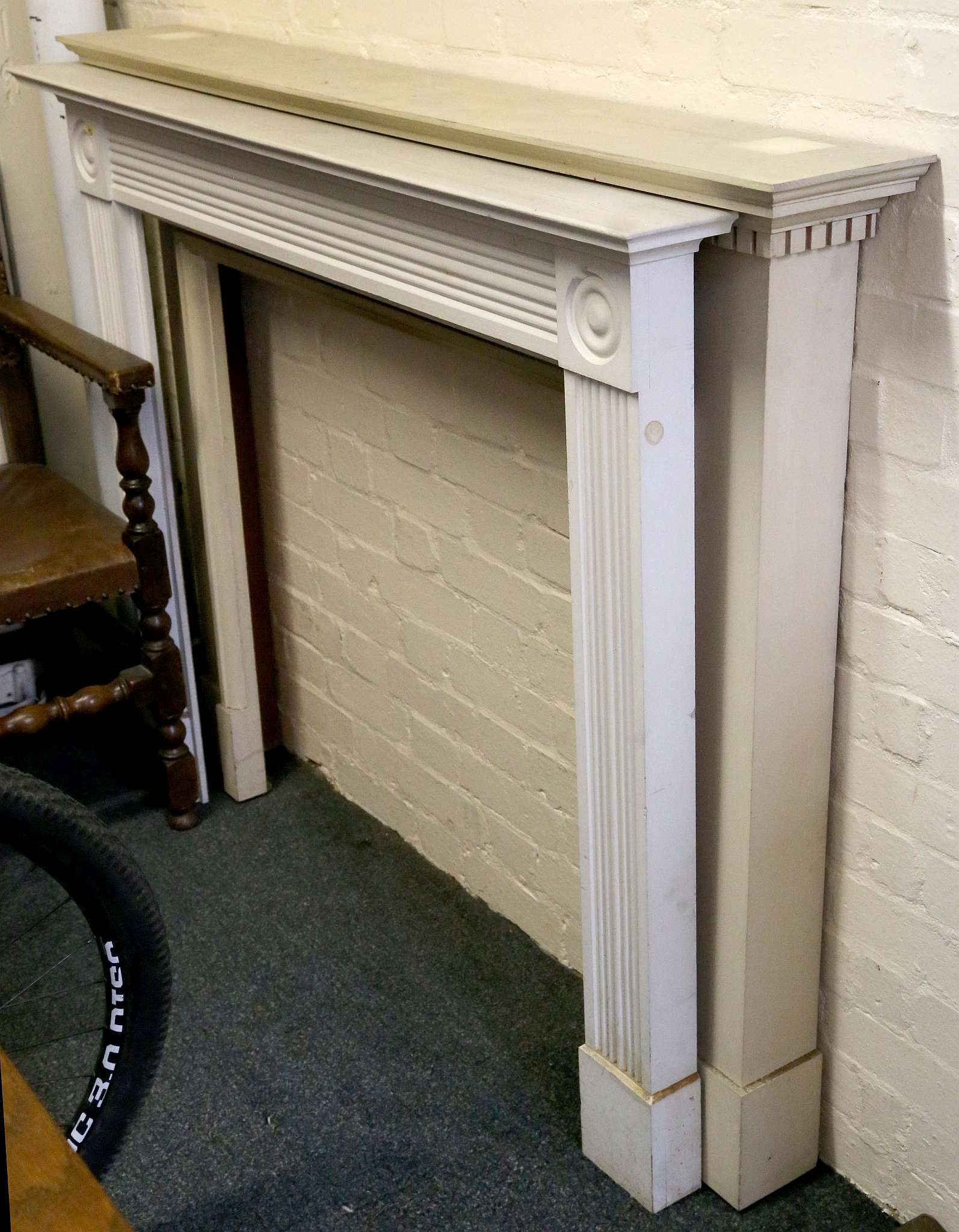 Two white painted fire surrounds, one with applied Adam style decoration. (2)