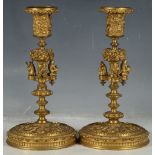 A pair of very unusual continental ormolu candlesticks with nozzle and drip pan on a decorative