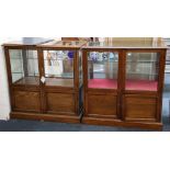 A pair of shop floor standing oak display cabinets with all round glass upper section, over