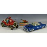 Three 1960s tin toys including a friction P-N police car, a battery operated fire tender, Made in