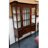 A good Edwardian mahogany and glazed display cabinet of “inverted, bowed” section with cupboards