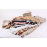 A quantity of fabric lengths and pieces including floral upholstery material and tapes, hooks and