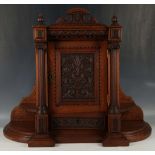 A continental desk top cabinet, circa 1890, the flame finials and carved capital, urn leaf and