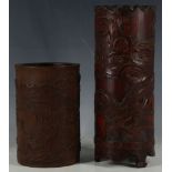 A 20th Century Chinese bamboo brush pot, relief carved with oriental landscape, together with