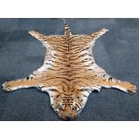 A vintage Bengal tiger's rug, signs of wear, size (head to tail) 260cm.
