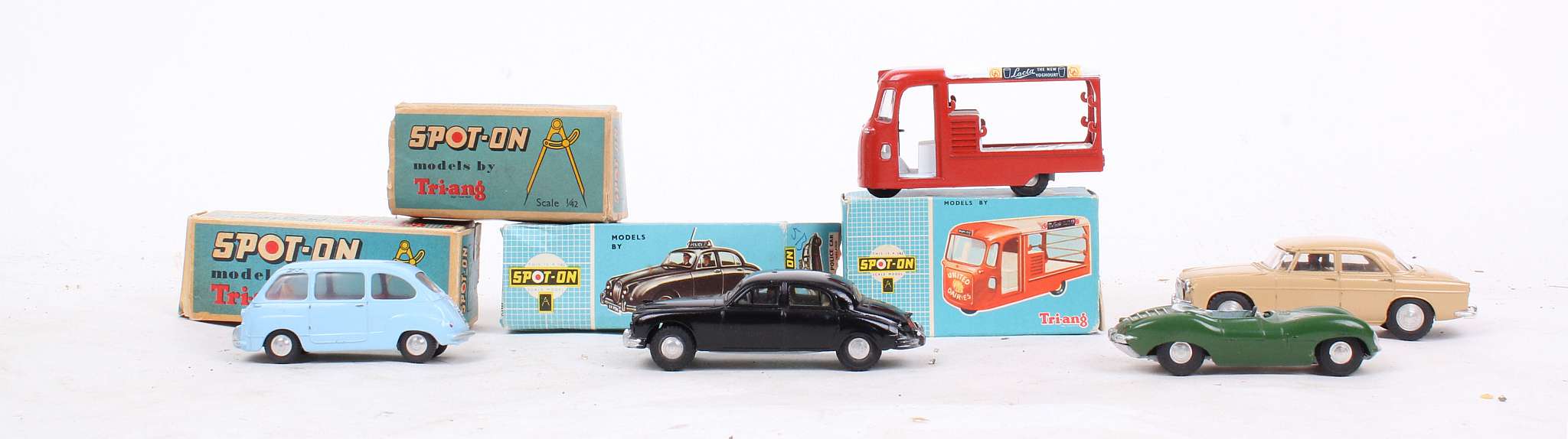 Five spot-on vehicles including 122 United Dairies van boxed (lacks chains); 256 Jaguar police