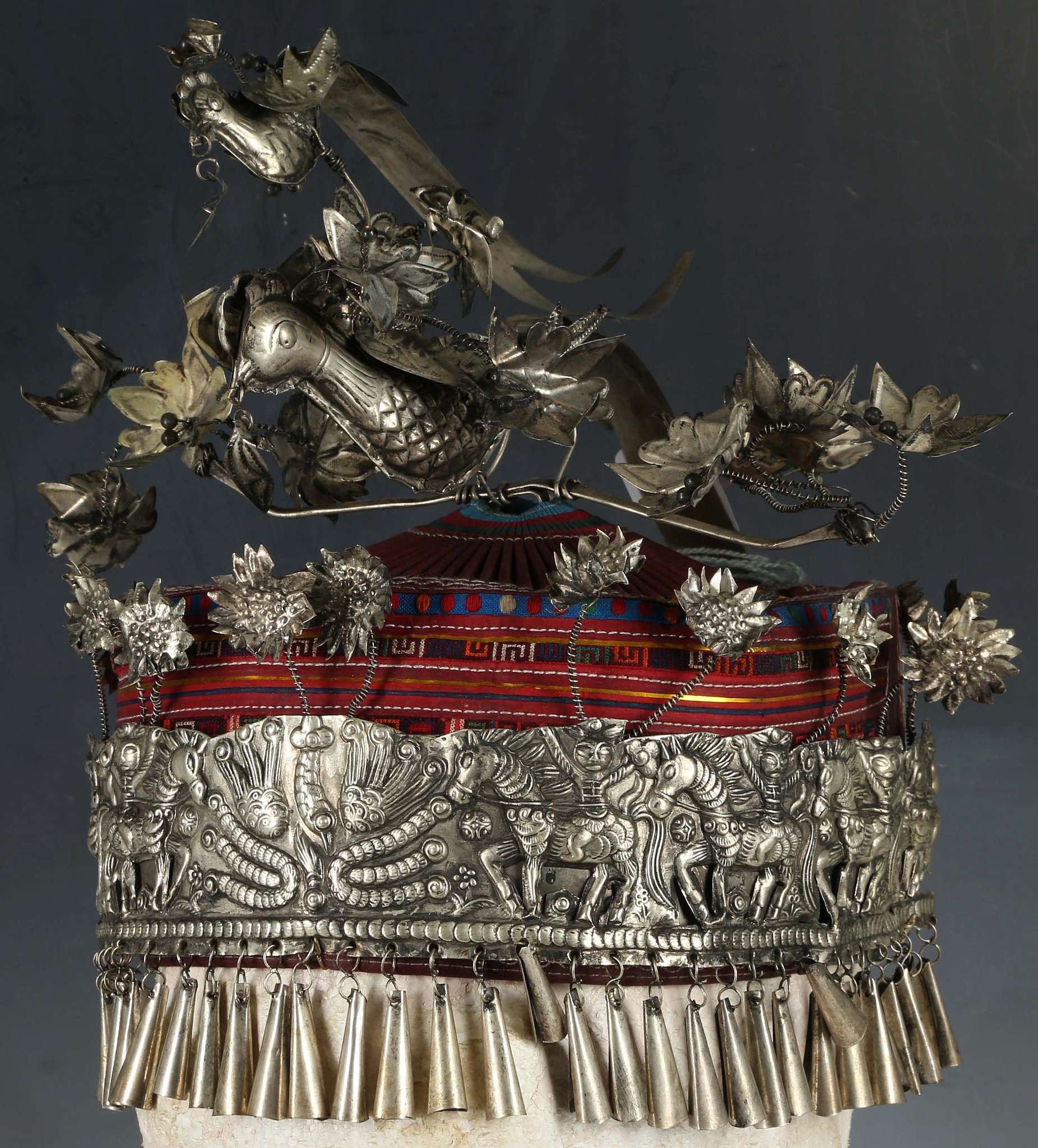 A Chinese miao ethnic minority, tribal headdress, ornately decorated with birds in white metal.