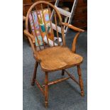 An antique yew wood stickback Thames Valley elbow chair.